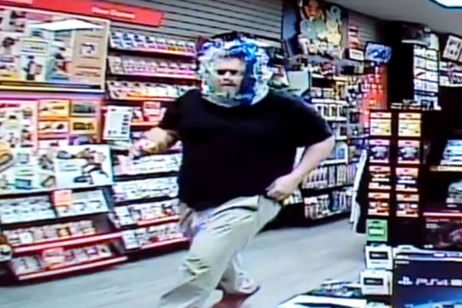 Un hombre roba en una tienda de videojuegos con una bolsa en la cabeza Un hombre roba en una tienda de videojuegos con una bolsa en la cabeza